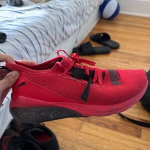 A red with some details of black puma shoe